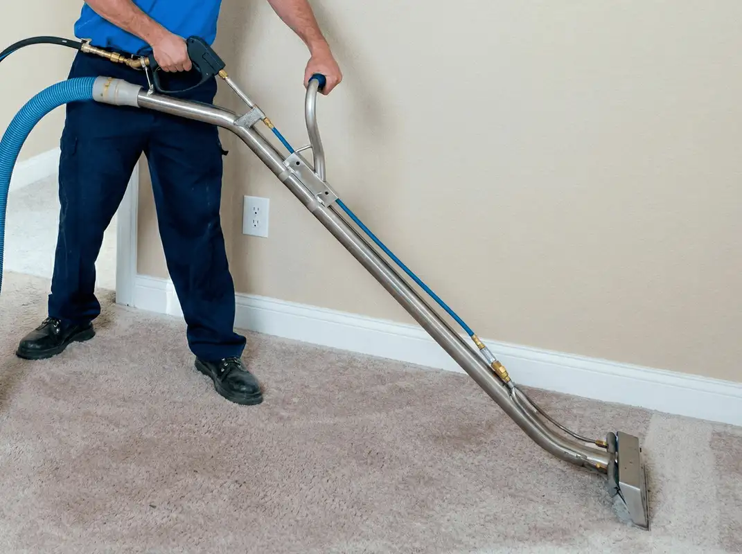 Professional operating a liquid removal machine on a carpeted floor in Boston, MA