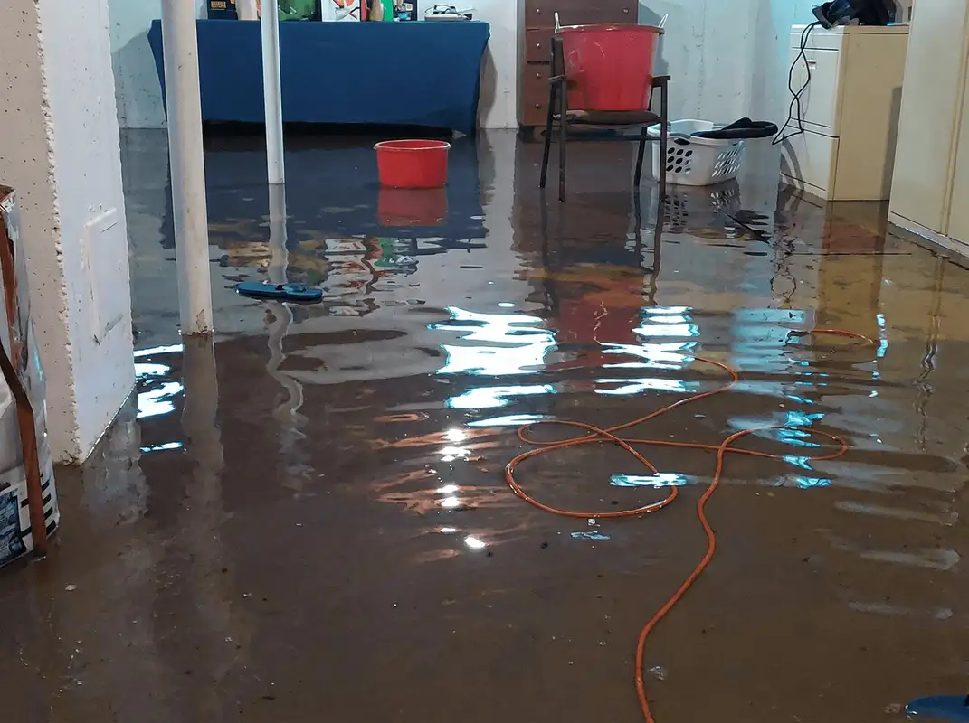 Basement with boiler, cabinets and washing machine completely flooded in Boston, MA