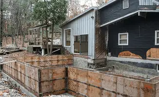 Prepared site with foundation forms for home remodeling and addition project in Boston, MA
